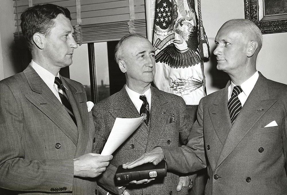 State Department Chief of Protocol Stanley Woodward, Sr. administers the oath of office to Hilldring