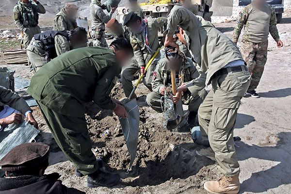 Afghan Local Police (ALP) fill sand bags during the construction of a traffic checkpoint in Jegdalay district, Kabul Province, Afghanistan, 5 March 2014.