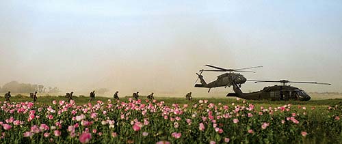 U.S. Special Forces team members with Special Operations Task Force - South board two UH-60 Blackhawk helicopters following a clearing operation in Panjwa'i district, April 25, in Kandahar province, Afghanistan