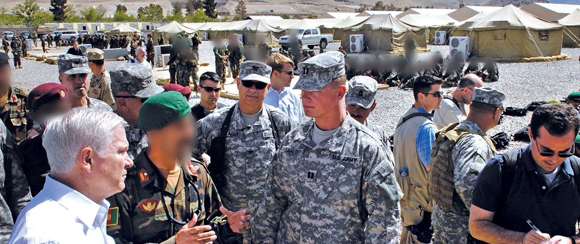 Secretary of Defense Robert M. Gates, left foreground, receives a tour of the Camp Morehead