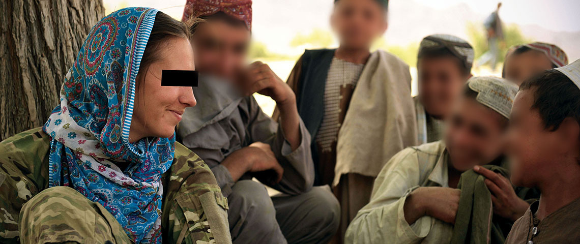 A CST-3 member supporting VSO for Special Operations Task Force-South (SOTF-S) talks with Afghan children.