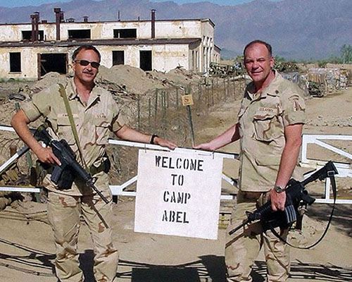 SGM Richard C. Kimmich nd CSM Christopher W. Abel at the access gate of Camp Abel