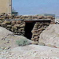 Expedient bunker to provide protection from indirect fire attacks.  Over time, these were replaced with above-ground concrete and sandbag bunkers.  In those early days the troops experienced random direct fire attacks which were gradually replaced with sporadic monthly indirect rocket or mortar attacks.