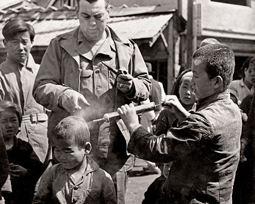 CA Teams in Korea dusted refugees with DDT to kill fleas and lice and to prevent the spread of diseases.