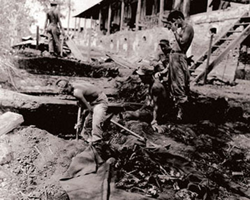 Medical personnel excavate bodies of American soldiers from Shelter A.