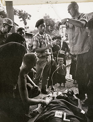 Non-uniformed U.S. personnel train Laotians in combat lifesaving techniques.