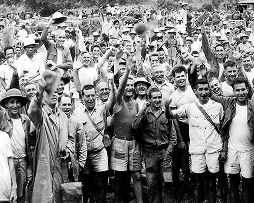 Former POWs from the Cabanatuan prison camp celebrate their rescue in the town of Guimba, Luzon, Philippines.