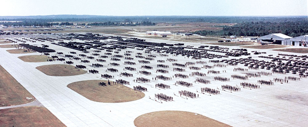 Aerial photo of the 82nd and 101st Airborne Divisions in formation on Pope Air Force Base (AFB), NC, awaiting the visit of President John F. Kennedy on 12 October 1961.