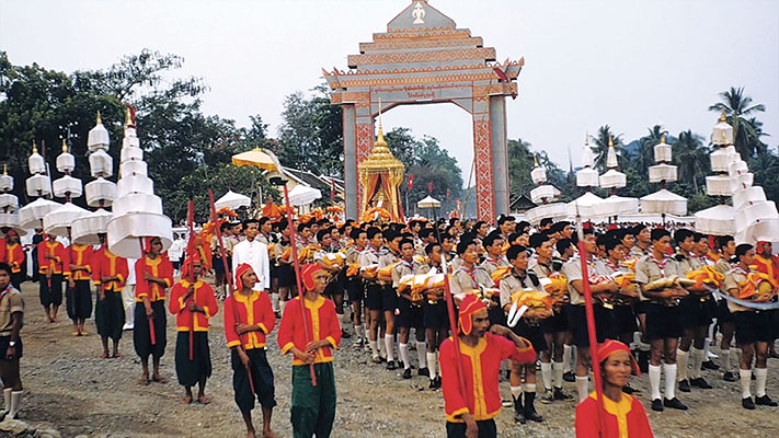 The funeral procession enters the soccer stadium where the cremation pyre was built, just outside of Luang Prabang.
