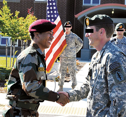 At the 25 August closing ceremony, MAJ Thaiba Simon, 1st PARA (SF) BN assault team leader, and MAJ Andy R. Rice*, ODB 1410 commander, exchange their country’s parachutist wings for the combined ‘friendship’ jump on 16 August from CH-47s belonging to 4/160th SOAR.
