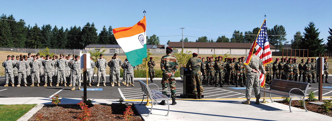 With Indian and American flags as a backdrop, COL Saha addresses the combined U.S.-Indian formation at the closing ceremony of Exercise VAJRA PRAHAR 2011, 25 August 2011.