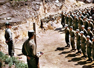 Captain Joseph Ulatoski, commander Task Force KIRKLAND, a U.S.-led anti-Communist partisan unit headquartered off the Korean east coast, addresses a formation of recent airborne graduates on the island of Nan-do, 1952.