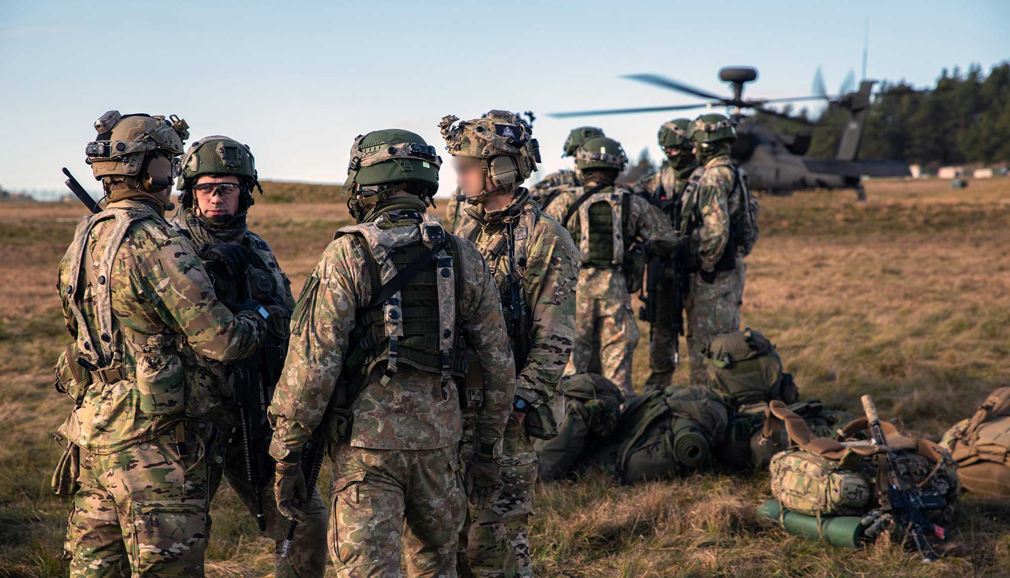 JFK's words in June 1962 continue to reverberate in the 21st century. Here, 10th SFG soldiers and their Lithuanian counterparts wait to board a U.S. Army UH-60 Blackhawk during Exercise Combined Resolve XVI on 6 December 2021, in Hohenfels, Germany. The exercise assessed the readiness of the 1st Armored Brigade Combat Team, 1st Infantry Division, and helped Ukrainian and Lithuanian Special Operations Forces hone their irregular warfare skills.