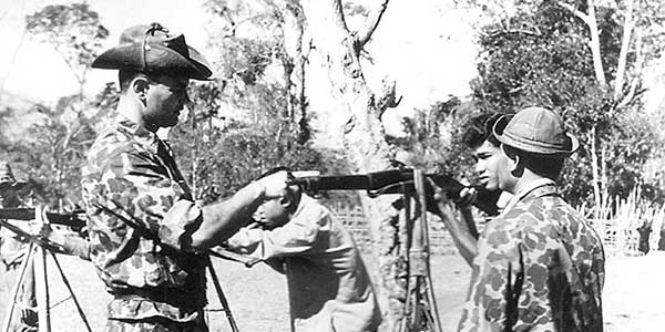 SF soldiers work with counterparts in the central highland village of Buon Enao, Republic of Vietnam, in early 1962.