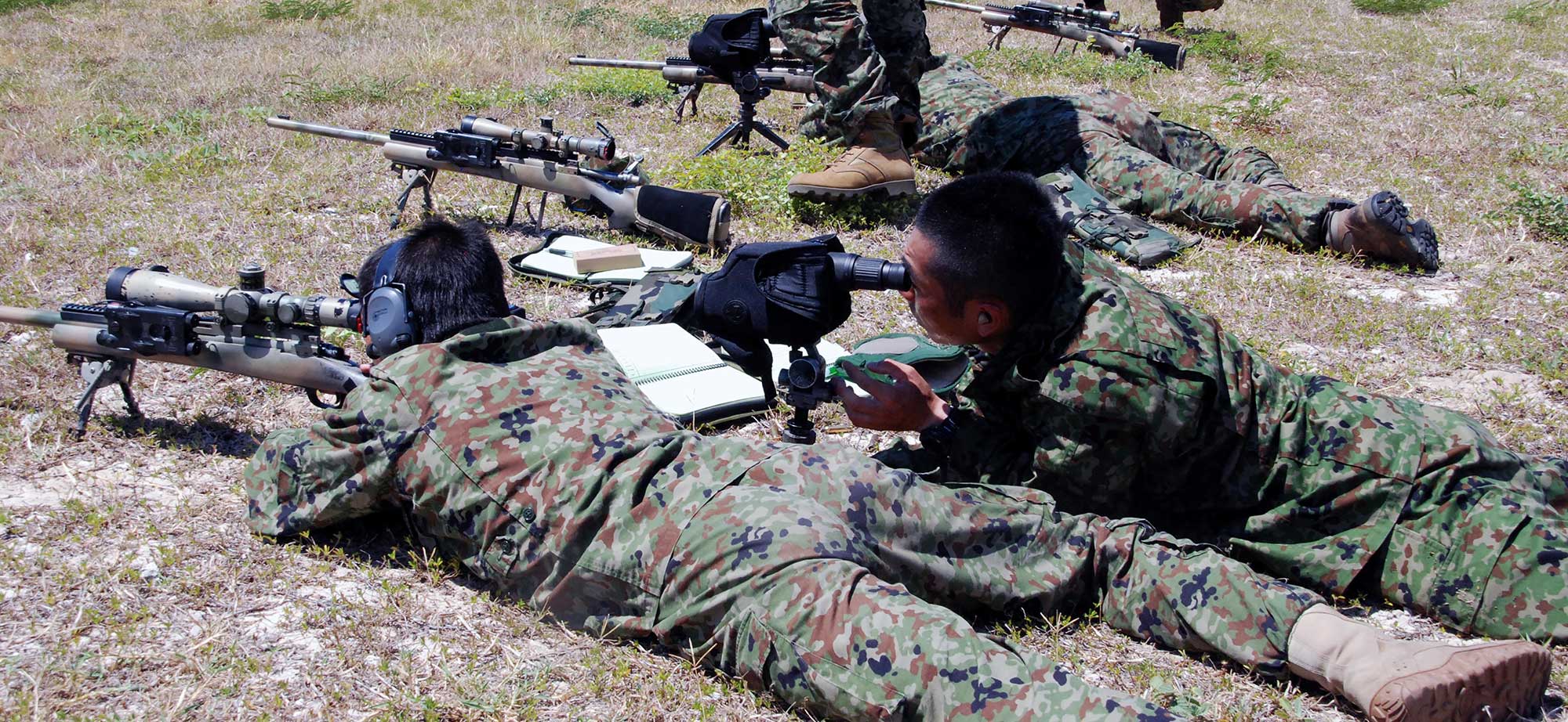 The ODA instructed the SFGp in sniper techniques. Here, a Japanese shooter uses the M24 Sniper Weapons System while another calls out hits with a spotting scope.