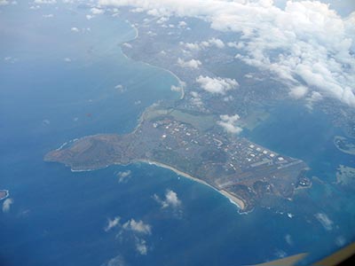 Marine Corps Base Hawaii from nearly 13,000 feet. The jumpers glided over the ocean to land near the airfield.
