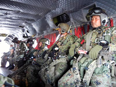 Fully-kitted members of the Japanese Military Freefall team await as the 25th ID CH-47 ascends to nearly 13,000 feet for the last HALO jump of SILENT EAGLE 2011.