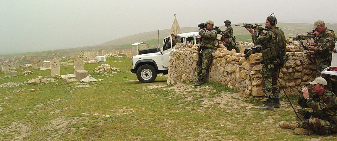 Special Forces team personnel observe the village of Ayn Sifni from the high ground to the north.