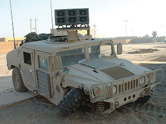 During an attack by insurgents, TPT 983’s M1205 HMMWV Armament Carrier loudspeaker vehicle crashed into a telephone pole. The team had to abandon the vehicle and ride back to the task force medical station on an M1A1 tank.