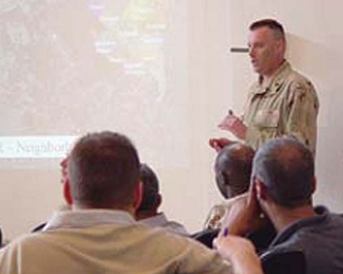 Officers in the Humanitarian Assistance Coordination Center (HACC) regularly met with nongovernmental and international organizations in order to maximize cooperation between the multitude of agencies and programs trying to rebuild Baghdad.