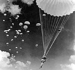 Hundreds of white parachutes dotting the sky over Camp Mackall became a familiar sight to residents of nearby towns during World War II. Early T-4 and T-5 static-line parachutes were even less maneuverable than today’s T-10 parachute, causing some locals to meet paratroopers sooner than later.