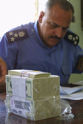 The Coalition Provisional Authority approved emergency funds for essential employees; officers in the Baghdad Police Department qualified for payments of $20 each, a considerable amount of money in the months following the collapse of Saddam Hussein’s regime.