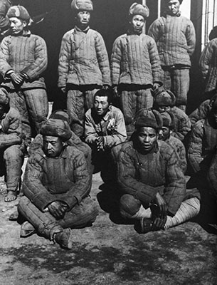 The quilted cotton uniforms worn by these captured Chinese soldiers illustrate one type of uniform supplied to the Tactical Liaison Office agents advised by Special Forces soldiers.