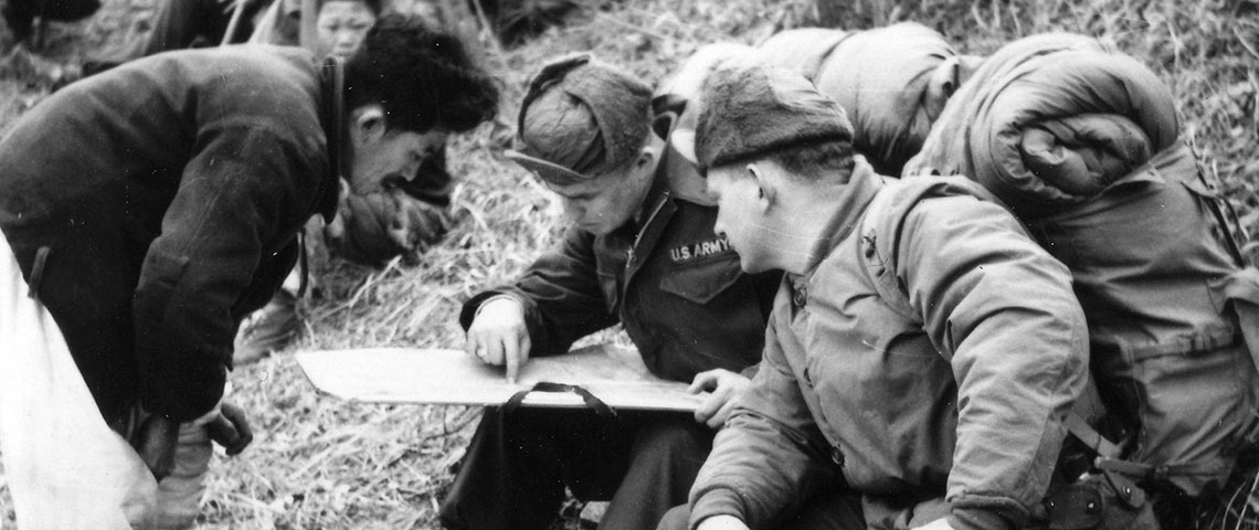 First Lieutenant Earl F. Thieme and an enlisted team member conduct a map reconnaissance for a suitable location for a cache. The plan to hide caches for stay-behind agents proved impractical.