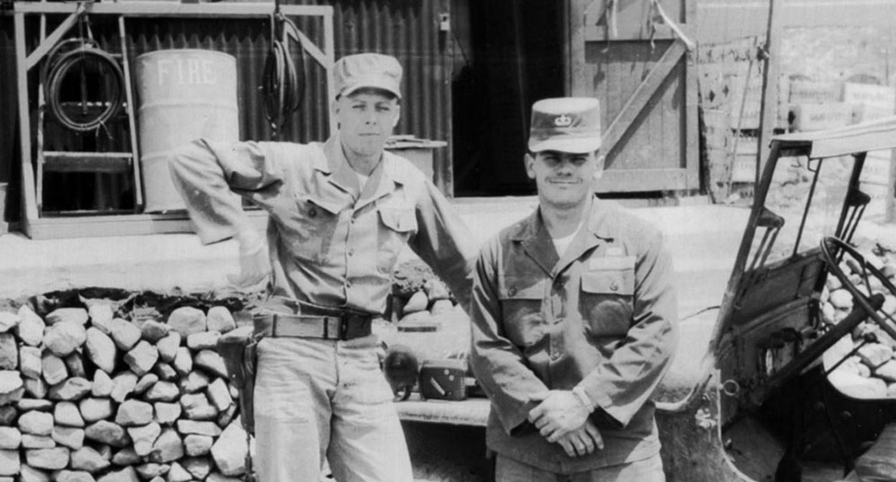 Corporal Oscar “Pete” Johnson, JACK parachute rigger, with Sergeant Tom Fosmire collecting supplies from the British post exchange at Pusan before shipping out on K-333.