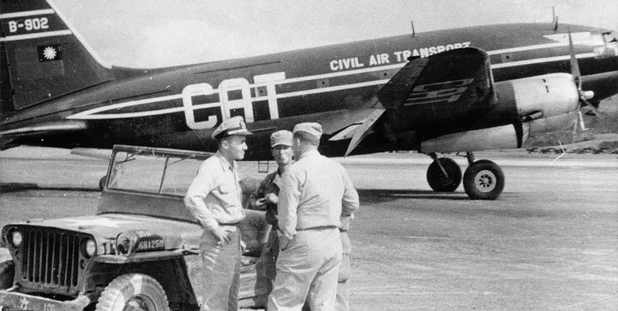 Civil Air Transport Curtiss C-46 Commando aircraft with JACK Navy Lieutenant George Atcheson, Korean Captain Han Chul-min, and Marine Major Vincent A. “Dutch” Kramer standing by their jeep.