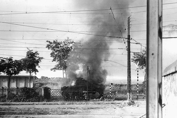 The first American tank (An M-4 Sherman tank from Task Force Howze) to enter Rome burns after a German ambush near the Pietralata rail yards on 4 June 1944.