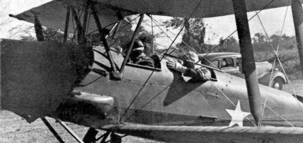 The de Havilland Gypsy Moth in which Lieutenant Colonel Eifler flew General Donovan behind Japanese lines to visit the KNOTHEAD group. In the rear and at the controls of the airplane is Lieutenant Colonel Carl Eifler, commanding officer of Detachment 101. General William J. Donovan is in the front seat.