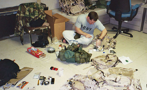 With it spread out on the barracks floor, Major Calvin Striker organizes some of the combat equipment issued at Fort Campbell on 14 December 2002.