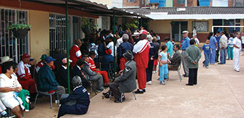 Locals wait in the school courtyard for a variety of medical activities during the Fusagasugá MEDRETE. The waiting provides a good time for various counter-drug and pro-government messages.
