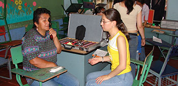 Volunteers provide optometry exams in a classroom. The mobile optometry kits allow the volunteers to provide eye exams and prepare classes in a relatively short period of time.