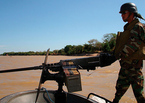 A Colombian Marine mans his M-2 .50 caliber heavy machinegun. The Marines and the Navy perform operations along Colombia’s rivers that assist in the Army in its counter-insurgency mission.