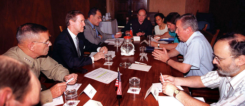 Secretary of Defense William Cohen and Minister of Defense José Florencio Guzman conduct a bilateral meeting on 2 December 1998. The defense ministers are in Cartagena, Colombia, attending the Third Defense Ministerial of the Americas. Cohen is accompanied by General Charles Wilhelm, U.S. Marine Corps, commander, U.S. Southern Command; and Peter Romero, Assistant Secretary of State for Inter-American Affairs.