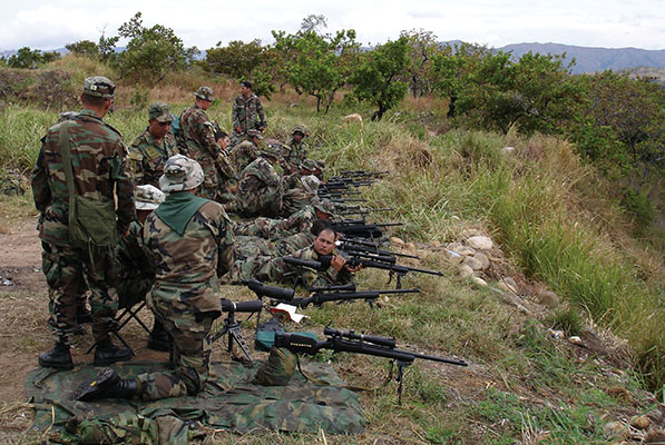 BACOA snipers and Americans firing at the sniper range. The M40 sniper system is clearly visible.