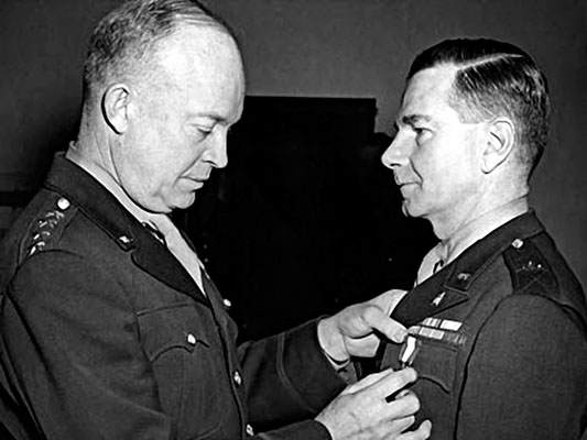 General Dwight D. Eisenhower presenting Brigadier General McClure with a Distinguished Service Medal as Chief of PSYWAR in World War II. McClure was the pick of the Secretary of the Army to revitalize PSYWAR in the service.