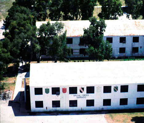 Troop barracks replaced Quonset huts for the soldiers at the school in the 1970s. These troop barracks were in use until 1995. Master Sergeant Sam Foster painted the Group flashes on the buildings in 1988.