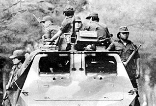 Guardia Nacional troops conducting highway security with an armored car.