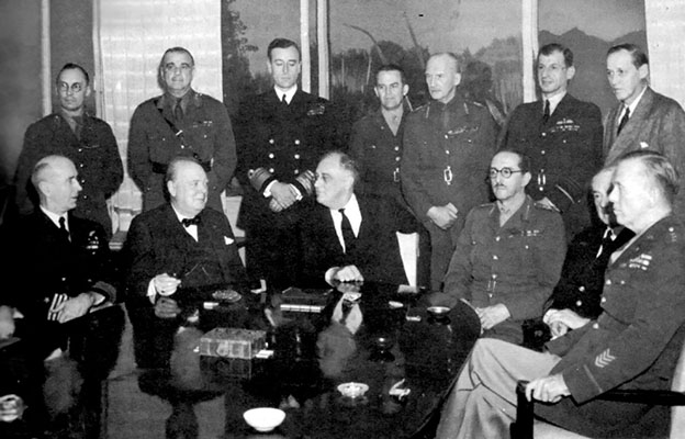 British Prime Minister Winston Churchill and U.S. President Franklin Delano Roosevelt with the Combined Chiefs of Staff at the Casablanca Conference. The meeting resulted in the decision to invade Sicily and Italy.