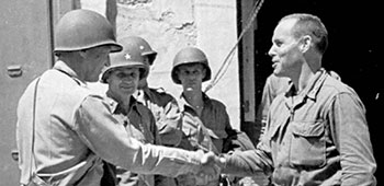 Lieutenant General George S. Patton, Commander of Seventh Army, greets Lieutenant Colonel Darby after the landing at Gela, Sicily. Darby’s Rangers led the American amphibious assault.