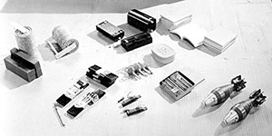 Here is a selection of OSS “gadgets” dropped into occupied Europe. Among those pictured are a “pocket incendiary,” “fog signal,” “clam,” firing devices, and timing pencils. Such items were used for demolitions.