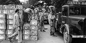 Unpacking ammunition at Area H. Notice the business sign still on the requisitioned civilian truck.