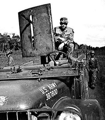 Specialist Fifth Class Vincent Skeeba behind a .30 caliber machinegun mounted on a ¾-ton truck. To his rear are part of the reaction force that fought to the ambush site.