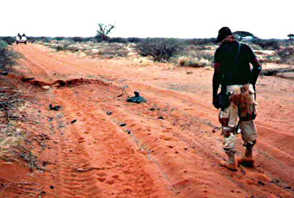 Staff Sergeant Jimmie Wilson, ODA 562, checking for mines with a mine detector near Belet Weyne.