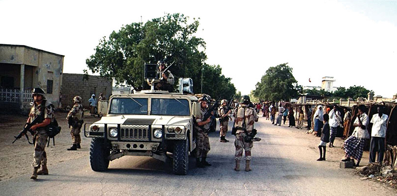 9th PSYOP Battalion HMMWV mounted with loudspeakers escorted by 10th Mountain troops broadcasting in Kismayo.