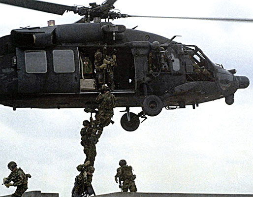 Army SOF soldiers fast-roping out of a 160th SOAR MH-60L Black Hawk helicopter.