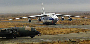 A huge Russian Antonov An-124 aircraft and a U.S. C-130 on the airfield at Bagram